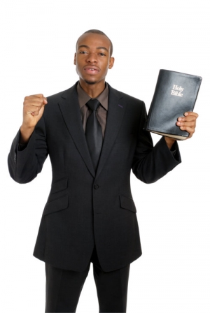 preacher holding the holy bible