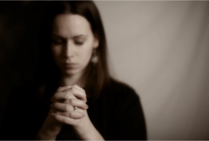 young woman praying intently