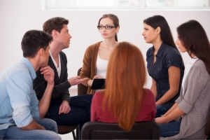 group meeting of people sitting in circle